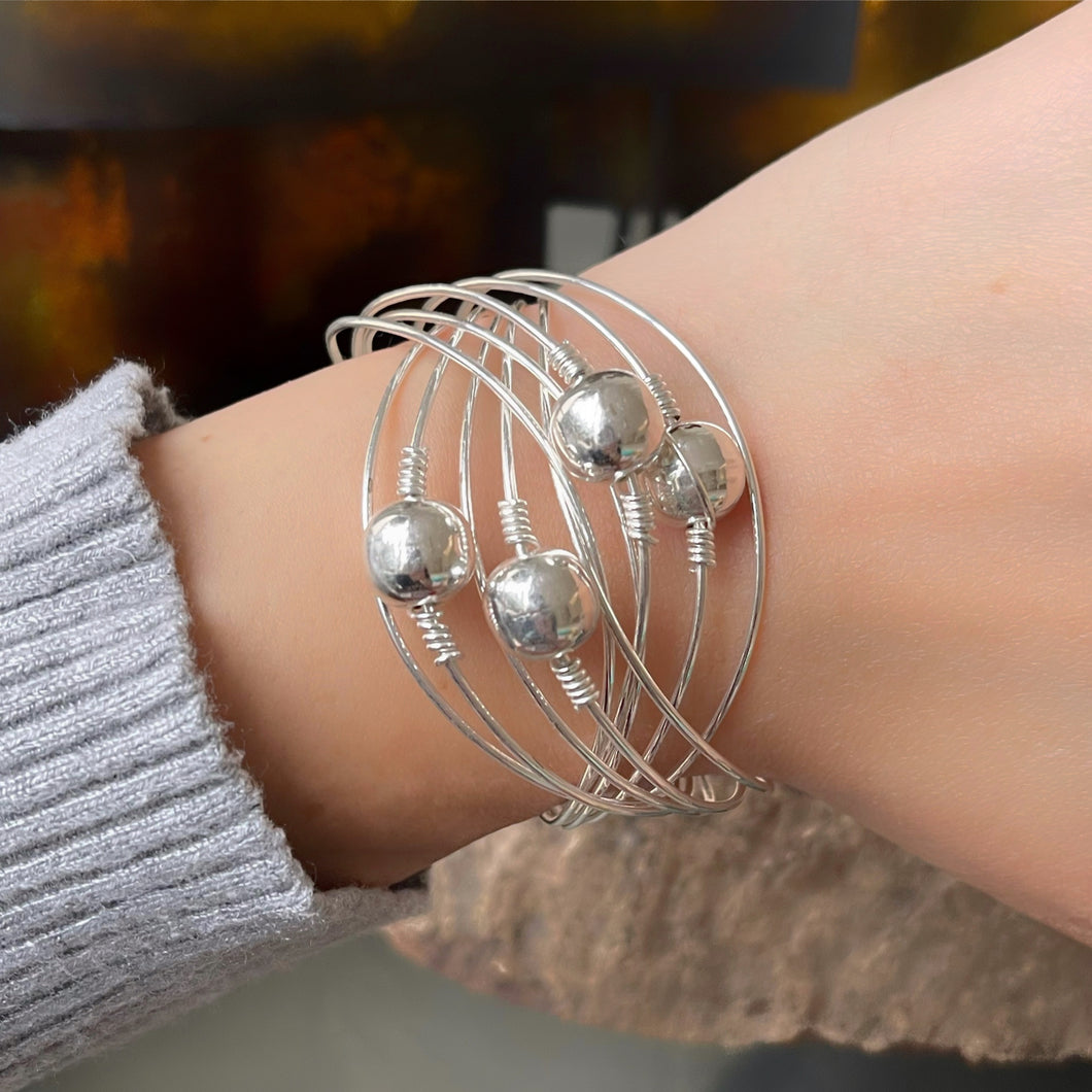 Pulsera de 10 aros en Plata 0.925 con 4 bolas